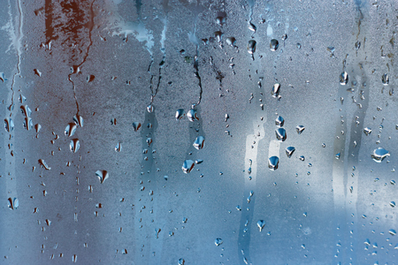 Drops of condensed steam on a transparent surface of glass or plastic. Texture of waterの写真素材