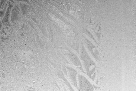 Black and white ice patterns on the glass. Monochrome winter background with a frosty textureの写真素材