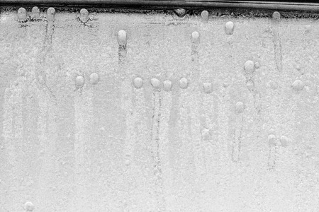 Black and white ice patterns on the glass. Monochrome winter background with a frosty textureの写真素材