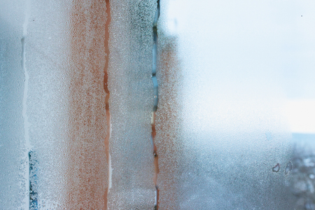 Close up detail of moisture condensation problem, hot water vapor condensed on the cold window glass, macroの写真素材
