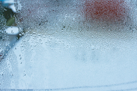 Close up detail of moisture condensation problem, hot water vapor condensed on the cold window glass, macroの写真素材