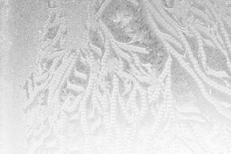 Black and white ice patterns on the glass. Monochrome winter background with a frosty textureの写真素材