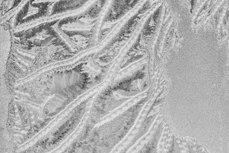 Black and white ice patterns on the glass. Monochrome winter background with a frosty textureの写真素材