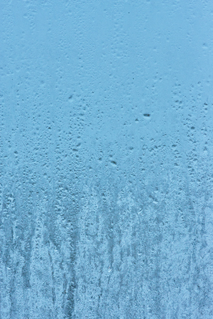 Frozen glass, ice texture on window, natural backgroundの写真素材