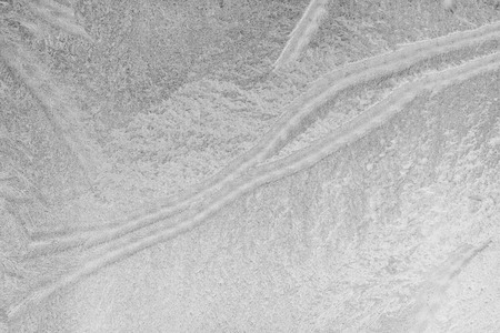 Black and white ice patterns on the glass. Monochrome winter background with a frosty textureの写真素材