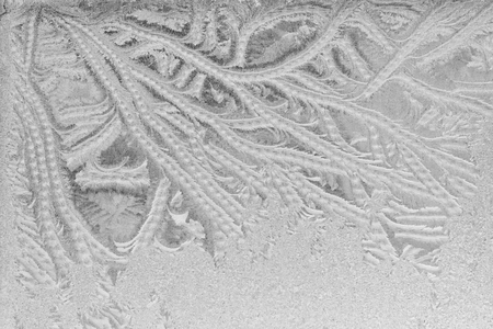 Black and white ice patterns on the glass. Monochrome winter background with a frosty textureの写真素材