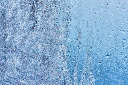 Frozen glass, ice texture on window, natural backgroundの写真素材