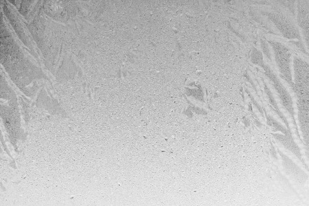 Black and white ice patterns on the glass. Monochrome winter background with a frosty textureの写真素材