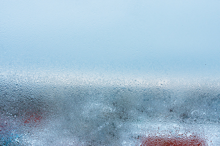 Close up detail of moisture condensation problem, hot water vapor condensed on the cold window glass, macroの写真素材