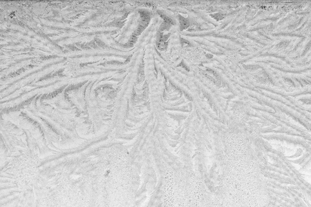 Black and white ice patterns on the glass. Monochrome winter background with a frosty textureの写真素材