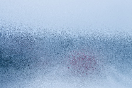 Blurry abstract background of foggy condensation on window glass natural surface. High humidity with formation of water dropletsの写真素材