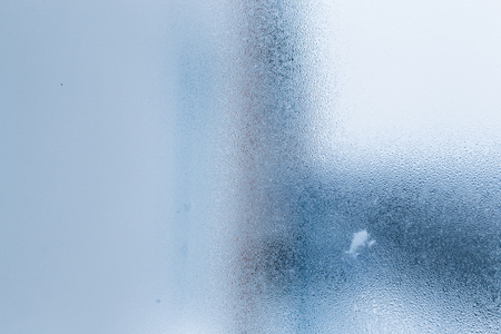 Background of natural water condensation, window glass with high air humidity, large drops drip. Collecting and streaming downの写真素材