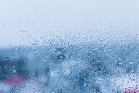 Background of natural water condensation, window glass with high air humidity, large drops drip. Collecting and streaming downの写真素材