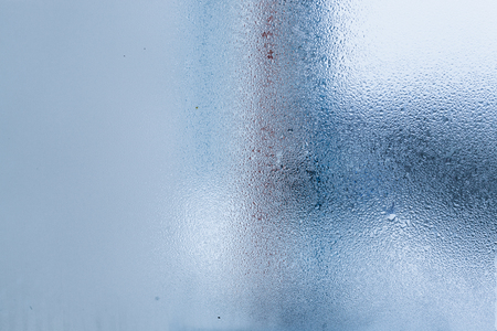 Background of natural water condensation, window glass with high air humidity, large drops drip. Collecting and streaming downの写真素材