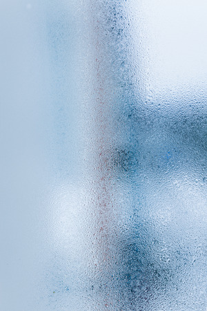 Background of natural water condensation, window glass with high air humidity, large drops drip. Collecting and streaming downの写真素材