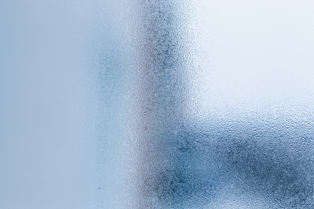 Background of natural water condensation, window glass with high air humidity, large drops drip. Collecting and streaming downの写真素材