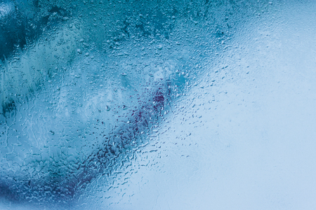 Background of natural water condensation, window glass with high air humidity, large drops drip. Collecting and streaming downの写真素材