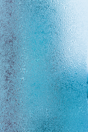 Background of natural water condensation, window glass with high air humidity, large drops drip. Collecting and streaming downの写真素材