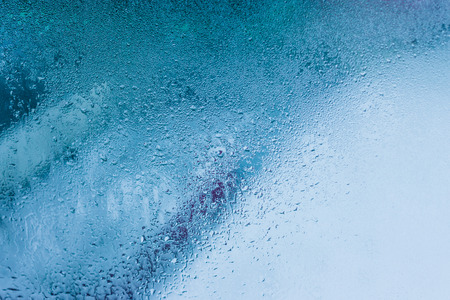 Background of natural water condensation, window glass with high air humidity, large drops drip. Collecting and streaming downの写真素材