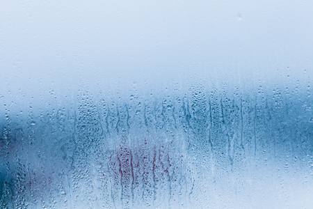 Background of natural water condensation, window glass with high air humidity, large drops drip. Collecting and streaming downの写真素材