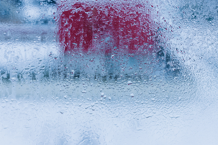 Background of natural water condensation, window glass with high air humidity, large drops drip. Collecting and streaming downの写真素材
