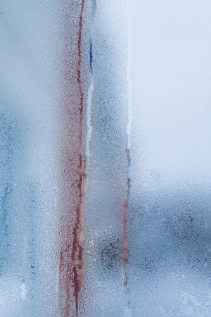 Blurry abstract background of foggy condensation on window glass natural surface. High humidity with formation of water dropletsの写真素材
