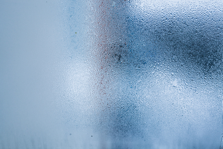 Background of natural water condensation, window glass with high air humidity, large drops drip. Collecting and streaming downの写真素材
