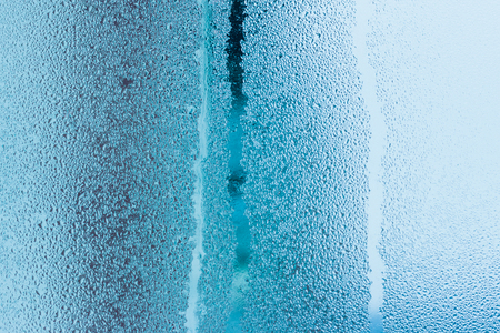 Background of natural water condensation, window glass with high air humidity, large drops drip. Collecting and streaming downの写真素材
