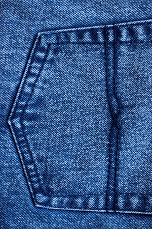 Blue jeans closeup view to abstract space of empty natural clean denim texture for traditional business background in cold bright colorsの写真素材