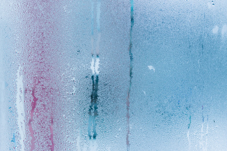 Background of natural water condensation, window glass with high air humidity, large drops drip. Collecting and streaming downの写真素材