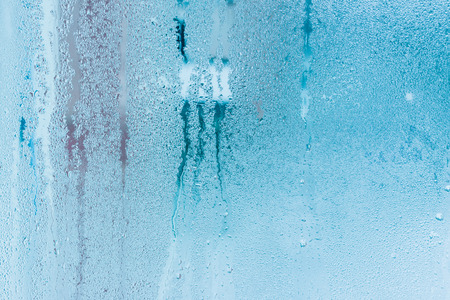 Background of natural water condensation, window glass with high air humidity, large drops drip. Collecting and streaming downの写真素材
