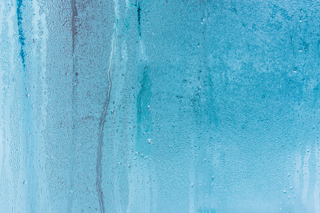 Background of natural water condensation, window glass with high air humidity, large drops drip. Collecting and streaming downの写真素材