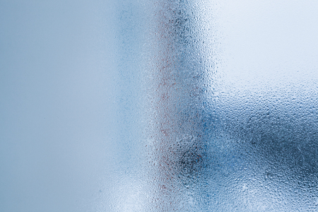 Background of natural water condensation, window glass with high air humidity, large drops drip. Collecting and streaming downの写真素材