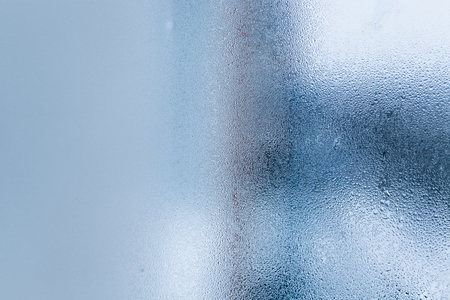 Background of natural water condensation, window glass with high air humidity, large drops drip. Collecting and streaming downの写真素材