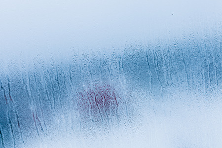 Condensation background with dew drops on glass window, humidity, foggy weather blank background. Outside the window winter, rain, autumnの写真素材