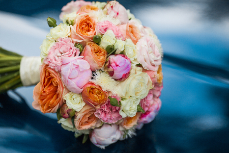 Wedding beautiful bridal bouquet of natural flowers, closeup with blurred backgroundの写真素材