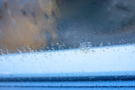 Water drops on blue glass, background photo of increased condensation, horizontal view, high quality