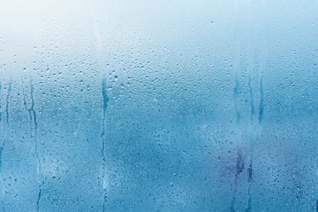 Condensation on the clear glass window. Water drops. Rain. Abstract background textureの写真素材