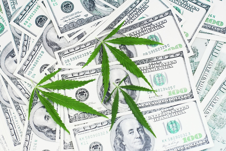 Cannabis leaf with money. Marijuana on background dollar.  Concept legalization of the drug business. Thematic photos pharmaceutical or medical industries.の写真素材