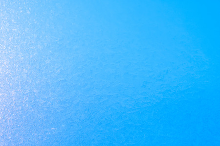 Background of frozen window glass, very strong frost and cold, texture in blue color, copy spaceの写真素材