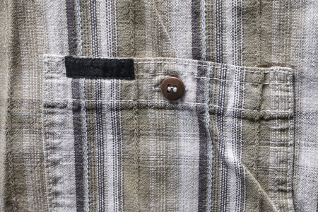 Close up part of a shirt from hemp fabric. Casual man's shirt with pattern. Wrinkled texture from...