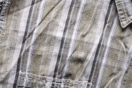 Close up part of a shirt from hemp fabric. Casual man's shirt with pattern. Wrinkled texture from...