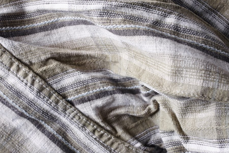 Close up part of a shirt from hemp fabric. Casual man's shirt with pattern. Wrinkled texture from...