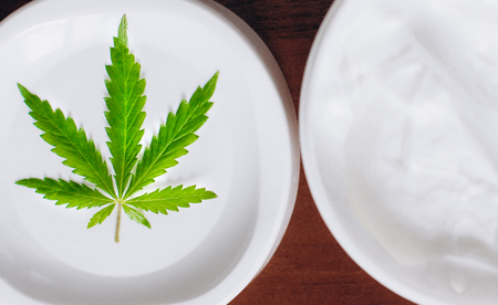 Cannabis oinment natural product. Cosmetic cream from natural hemp, moisturizing lotion with CBD content. Copy space for your designの写真素材