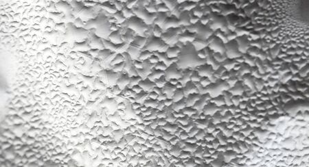 Water Drops On Foil Grey White Background, Texture colorful water drop. Abstract detail of moisture condensation problems, hot water vapor condensed on foil close upの写真素材