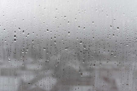 Dripping Condensation, Water Drops Background Rain drop Condensation Texture. Close up for misted glass with droplets of water draining downの写真素材