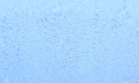 Frozen drops of condensation on a window, a sharp drop in temperature, sharply frozen drops of water on glass in winter, extremely cold low air temperaturesの写真素材