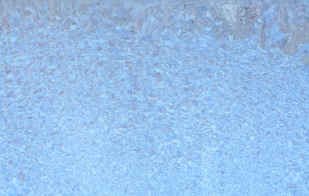 Natural frozen drops of condensation on transparent glass. Beautiful background from a frozen window in winter. Drops texture on the glassの写真素材