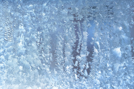Natural frozen drops of condensation on transparent glass. Beautiful background from a frozen window in winter. Drops texture on the glassの写真素材