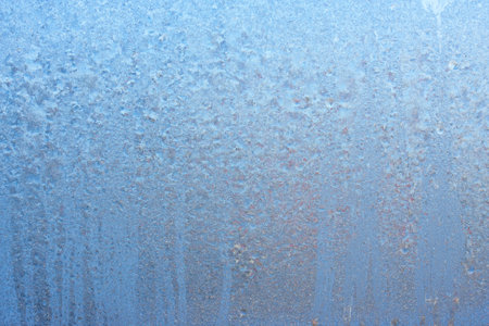 Beautiful natural background or texture of frozen transparent glass on the window in winter, strong cold concept, horizontal image, copy space for your design or textの写真素材